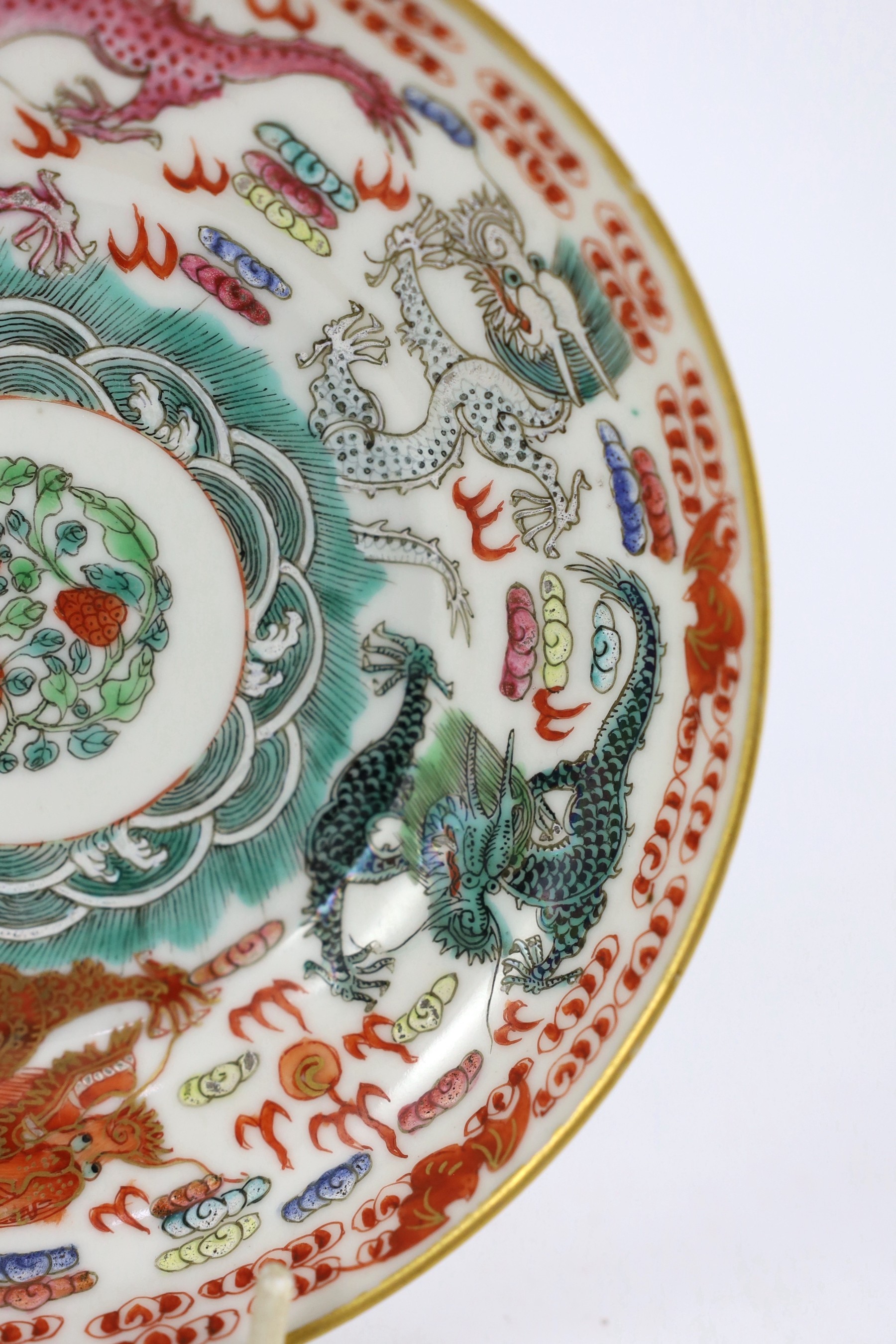 A Chinese famille rose fencai ‘dragon’ saucer dish, Jiaqing four character seal mark, 19th century, 14.6cm diameter